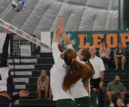#6 Brittany Yaxley and #21 Cassie Thompson go up for a block against the Sagehens (photo by Kay Hurd)